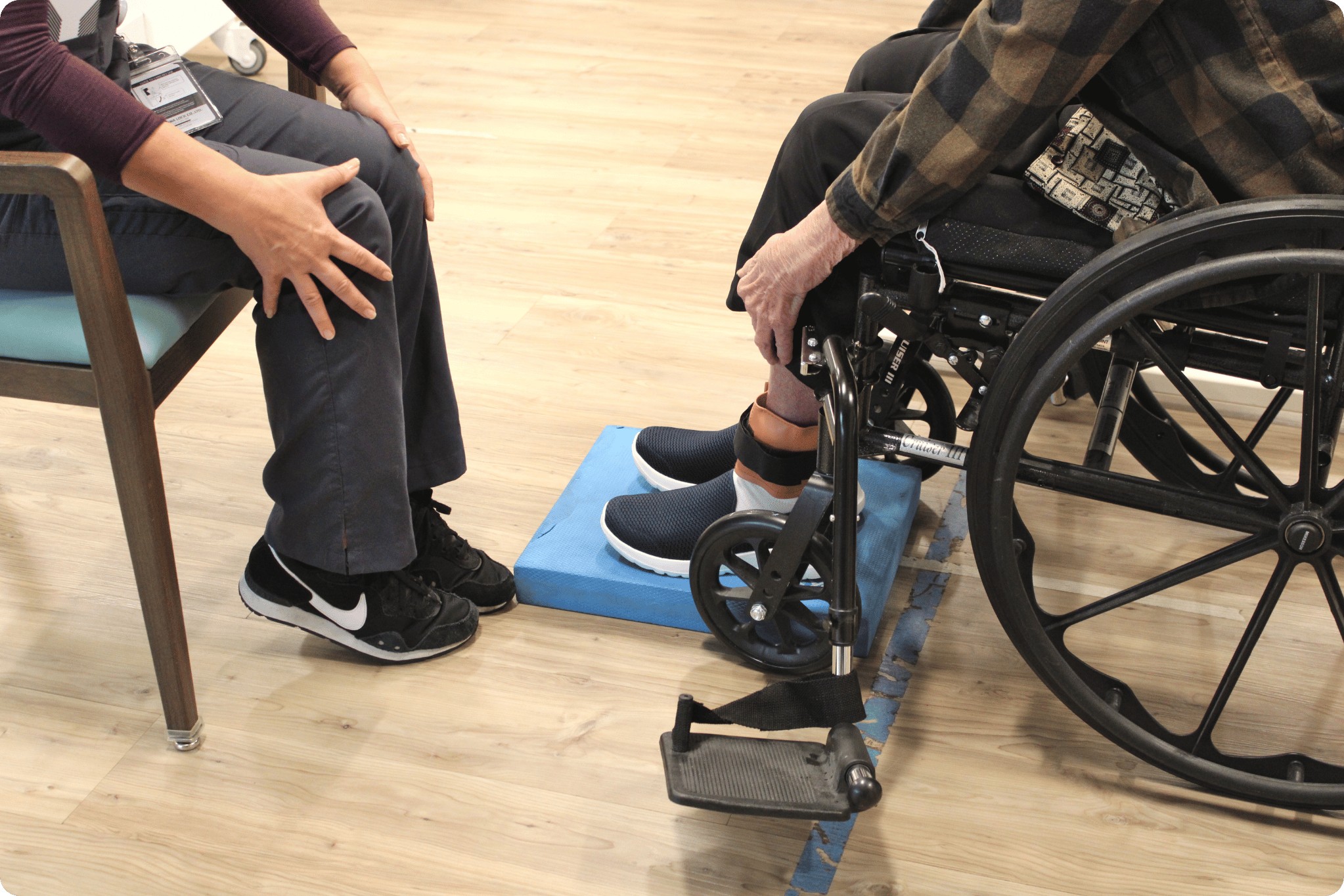 Physical therapist working with senior in wheelchair